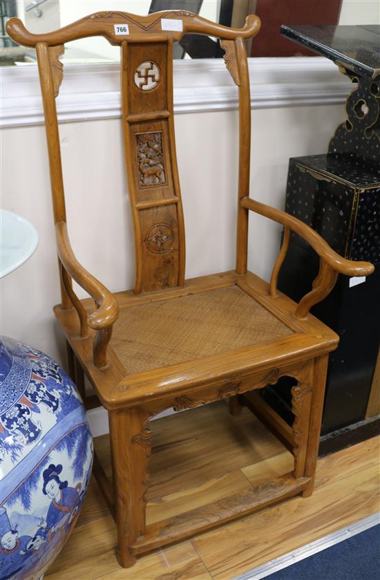 A pair of Chinese elm elbow chairs